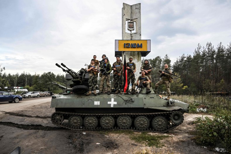 Soldiers pose outside of Izyum, eastern Ukraine