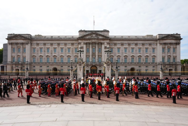 The Queen passes Buckingham Palace