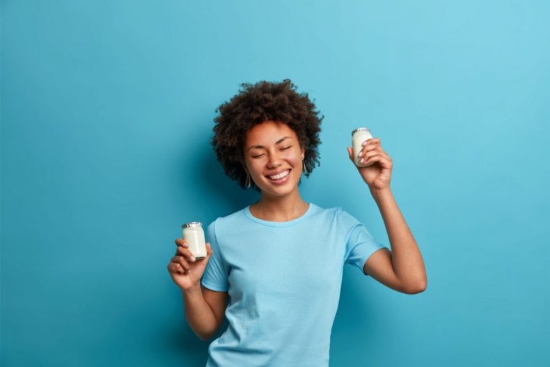 Woman holds tiny milk containers