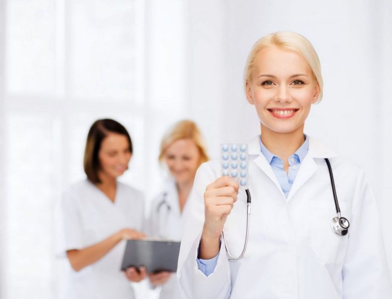 Doctor holding birth control pills