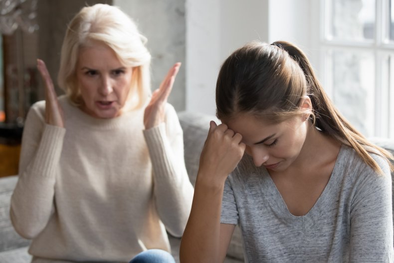 Woman scolding young adult