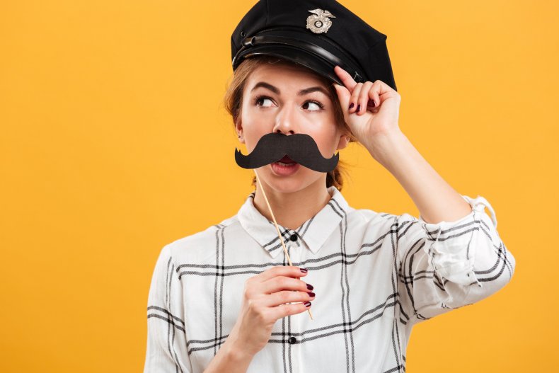 Woman wearing fake police hat and mustache