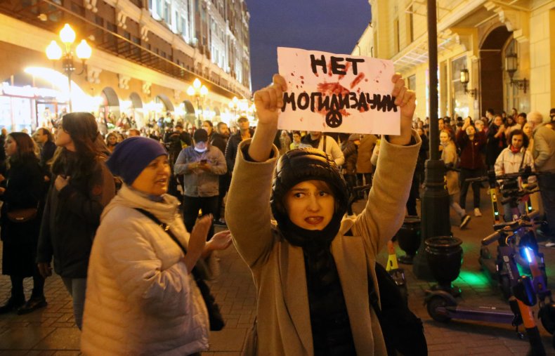A female activist holding anti-mobilization poster