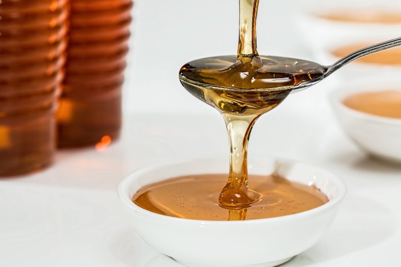 Honey being poured in stock image