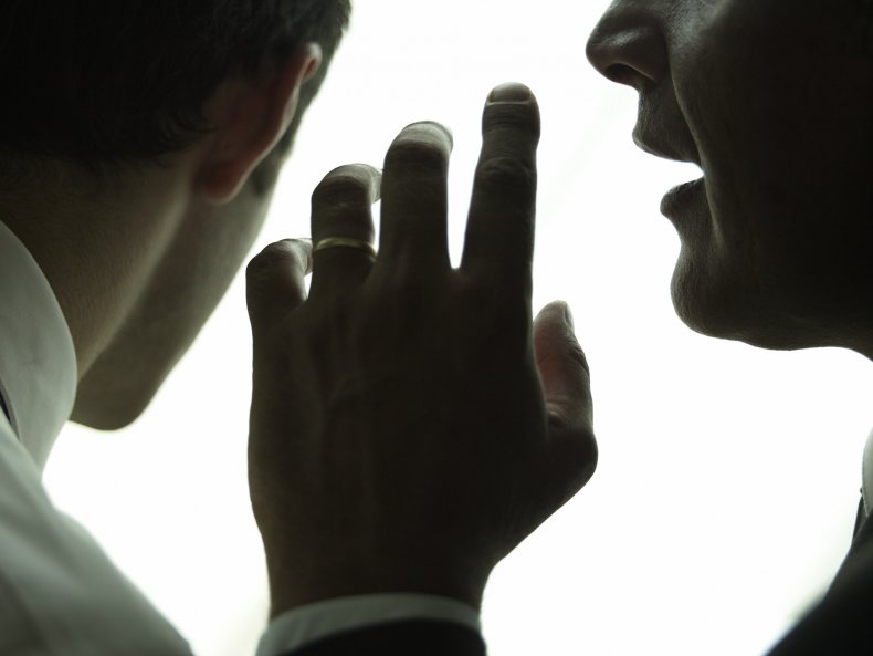 Man whispering to man