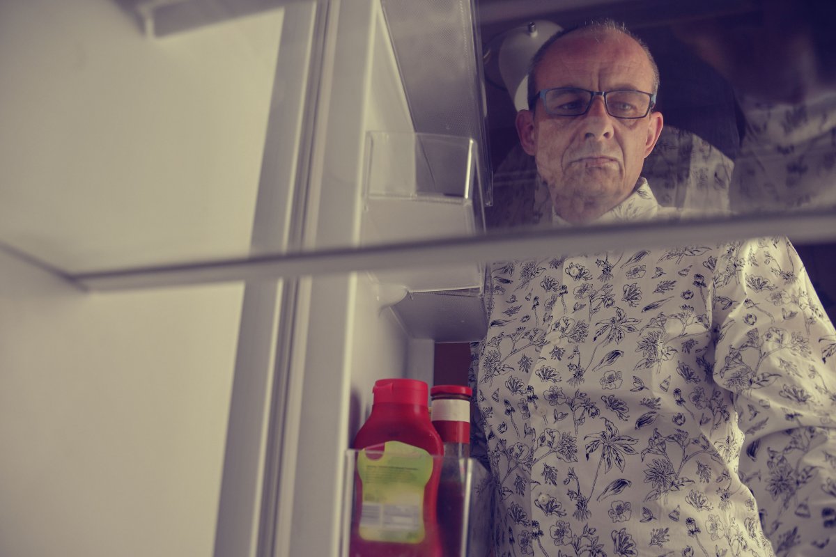 File photo of man looking in fridge.