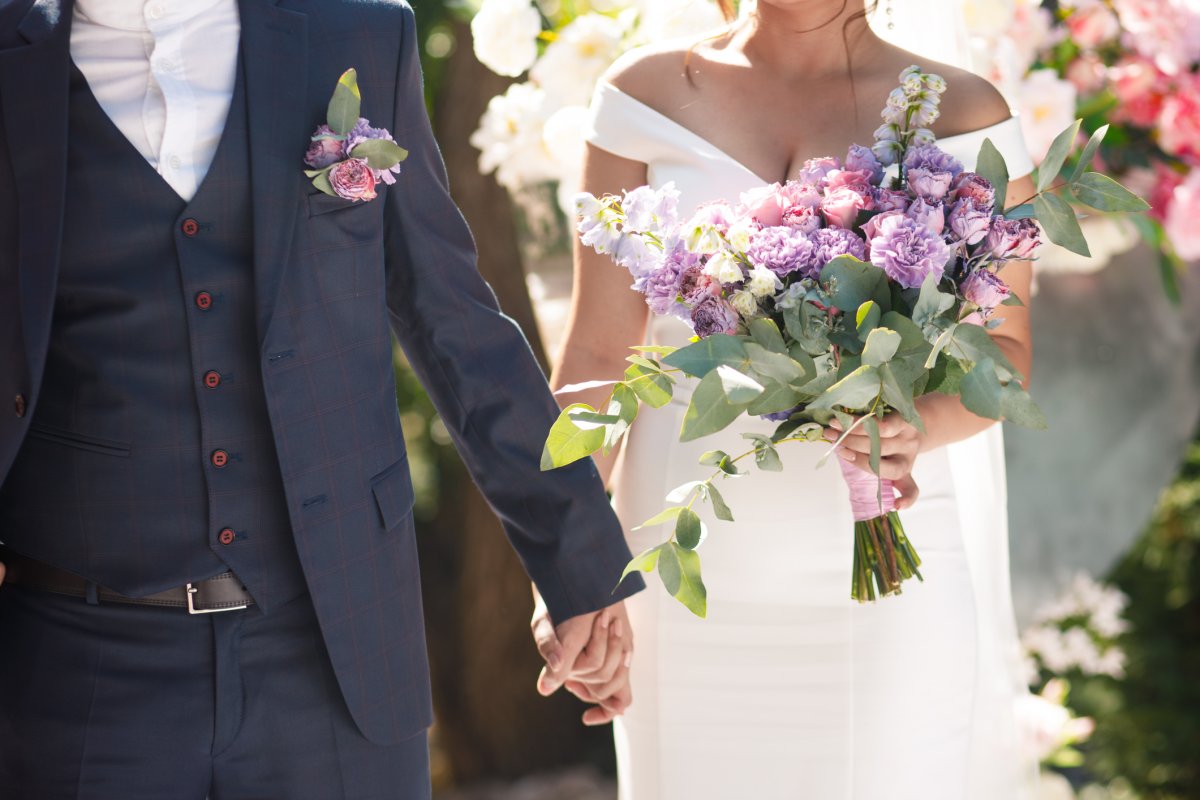 A groom holding hands with the bride