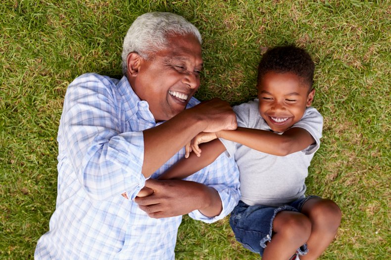 grandfather tickling his grandson