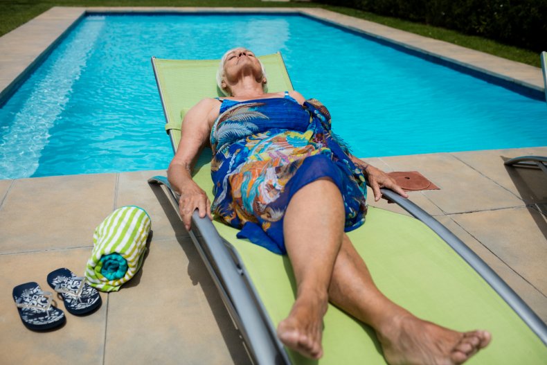 Elderly woman sleeps on a sun lounger