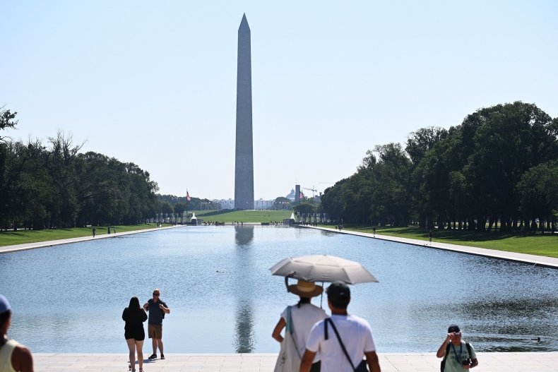 People use an umbrella to shelter from