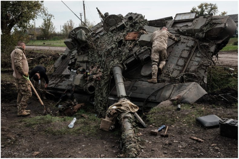 Photo of Ukrainian soldiers on a destroyed tank