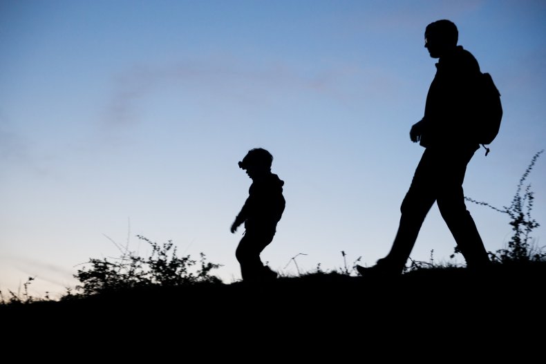 Two walking figures silhouetted as they stroll 