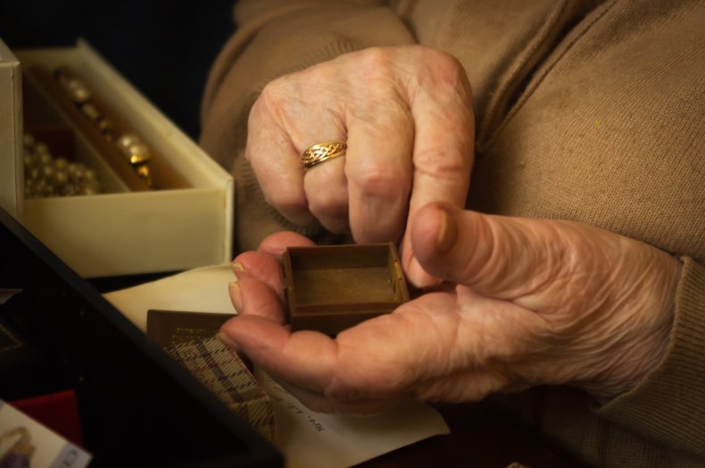 Old woman holding a ring 