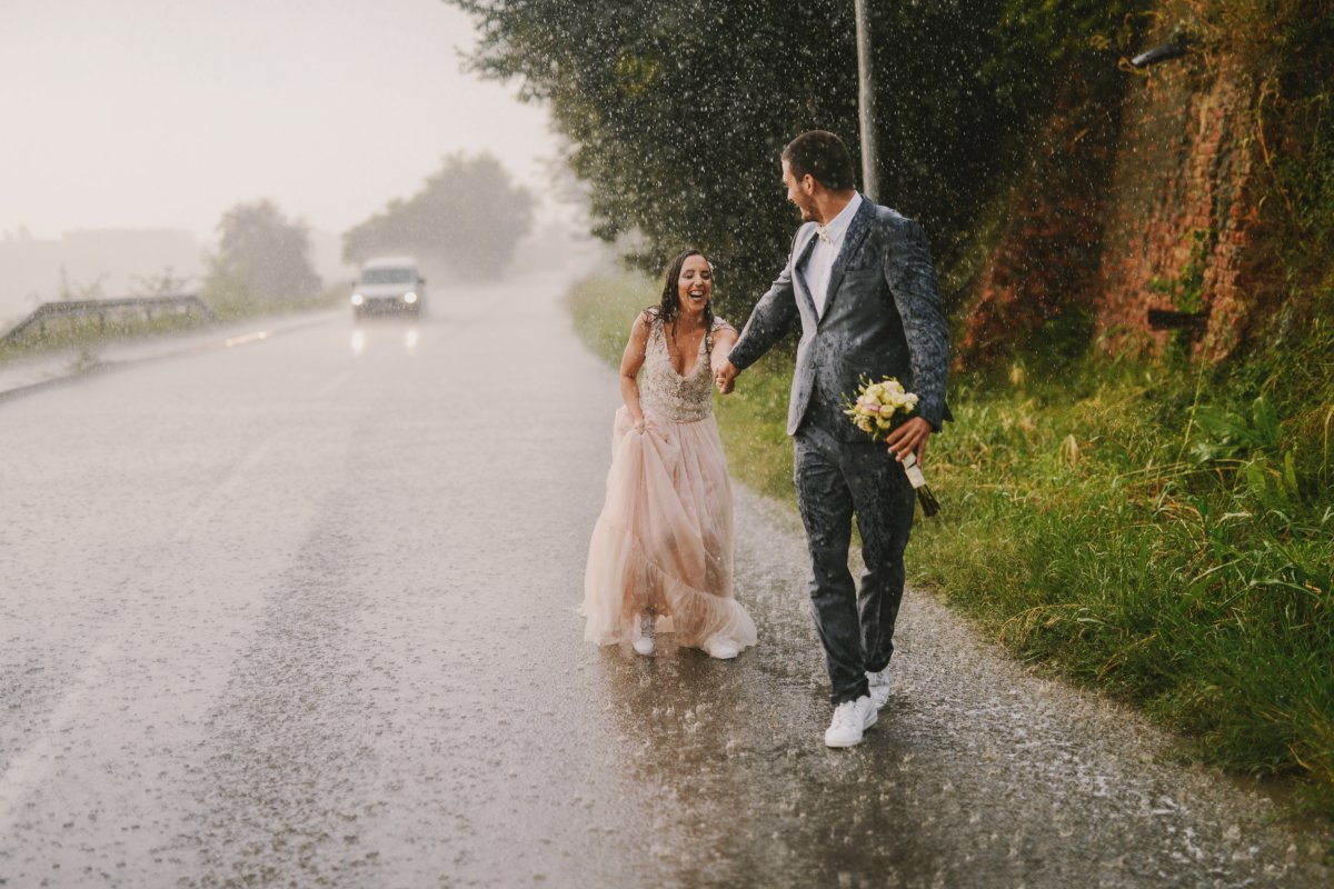 couple holding hands in the rain