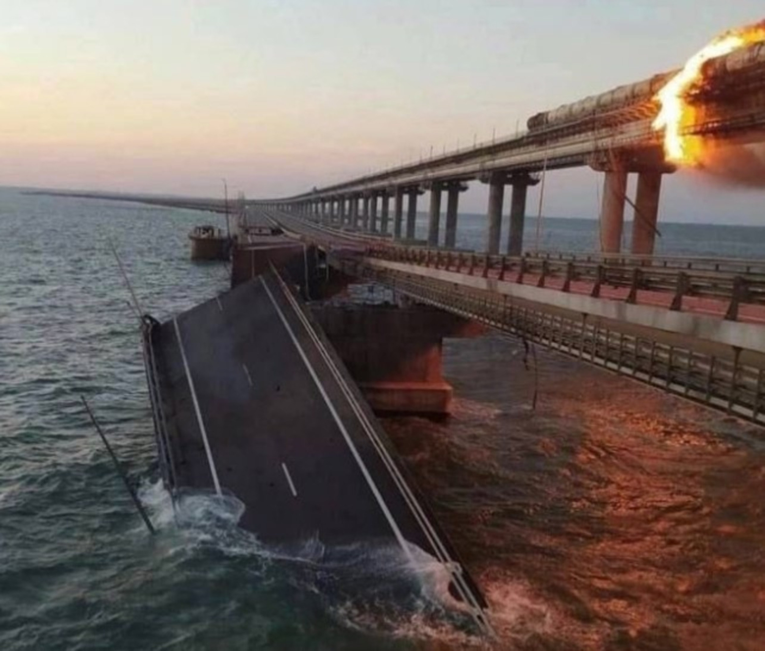 Crimean Bridge Hit by Explosion, Erupts in Flames as Heavy Damage Seen
