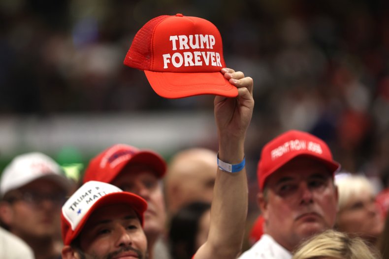 A Trump supporter holds a hat