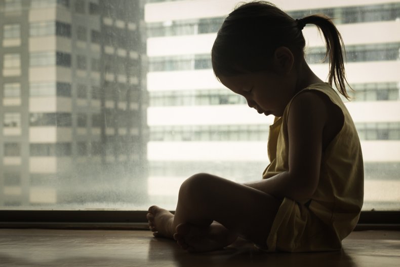 sad young girl at the window