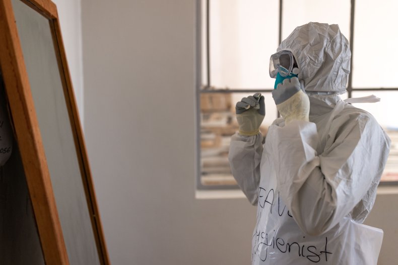 A health worker puts on PPE 