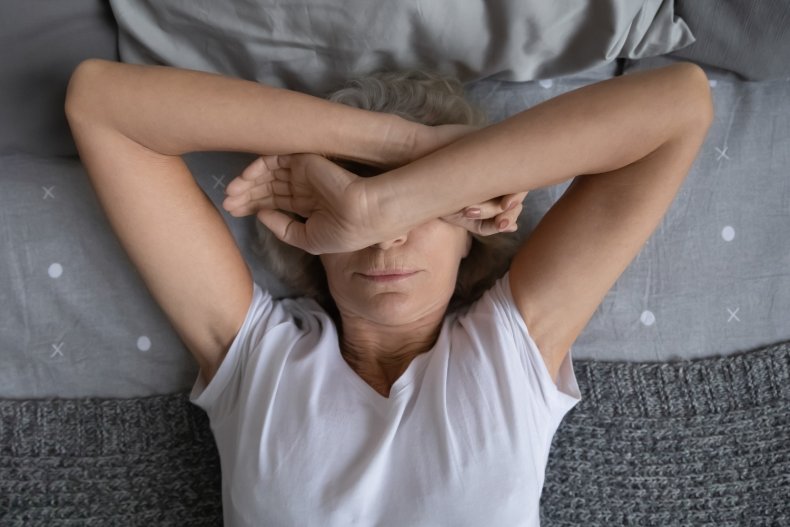 Stock image of tired woman in bed