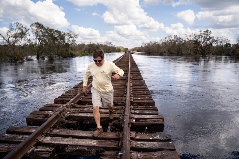 Man goes on railroad tracks in flood
