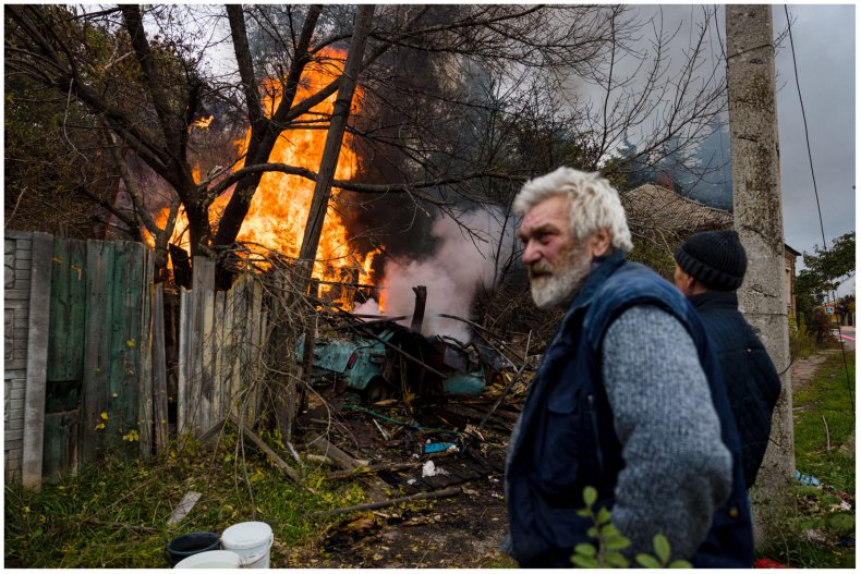 Ukrainians near a burning building