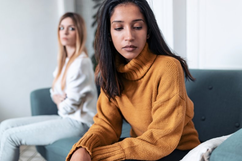 Women looking upset on couch.