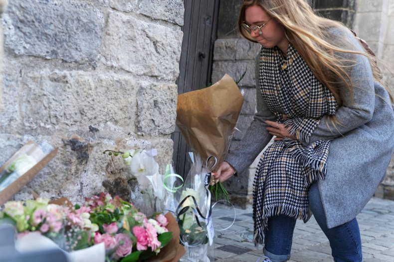 Woman lays flowers at Lola's funeral in France