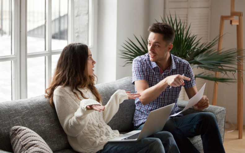 A couple arguing inside an apartment.