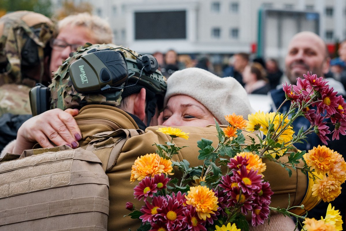 A woman hugging a Ukrainian soldier 