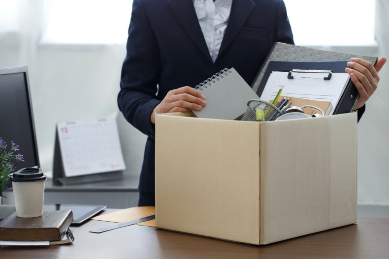 Employee packing belongings into cardboard box.