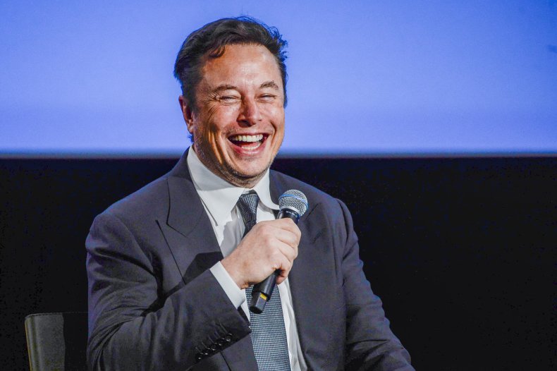 elon musk laughing holding microphone