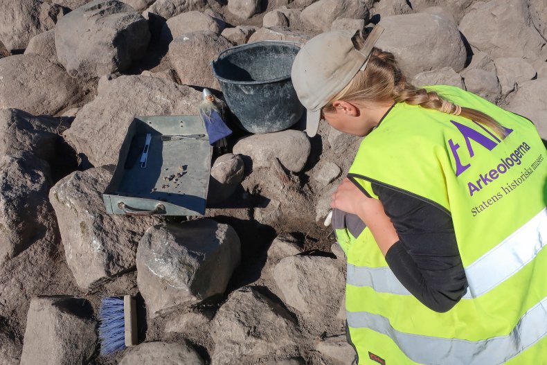 Archaeologist excavating Viking burial site