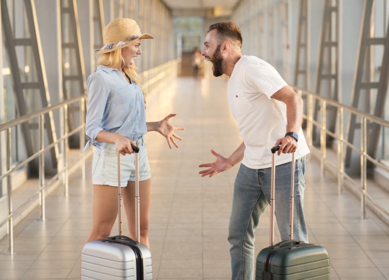 Couple arguing in an airport terminal
