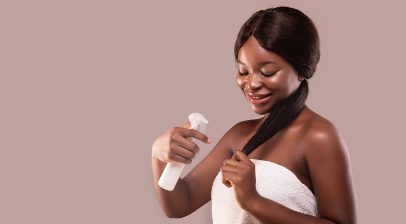 Black woman straightening hair