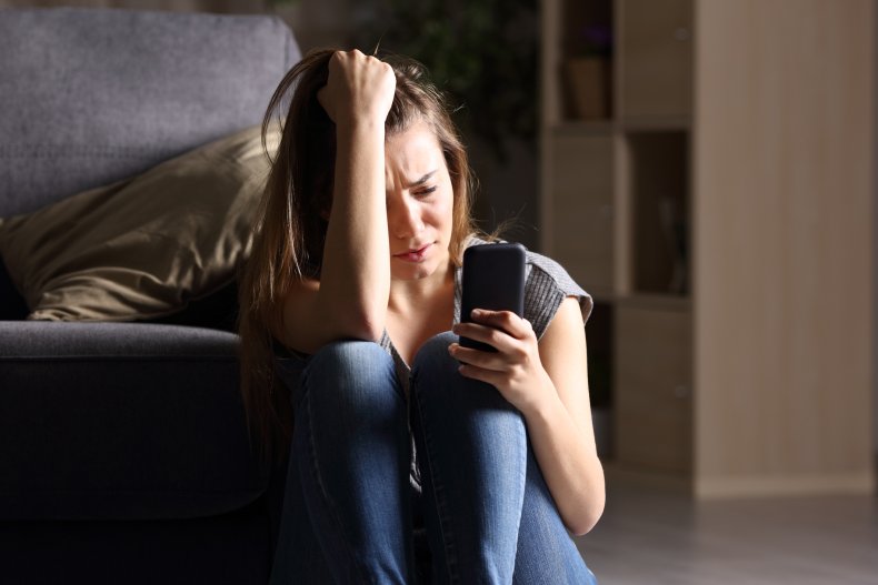 Upset woman looking at a cell phone 