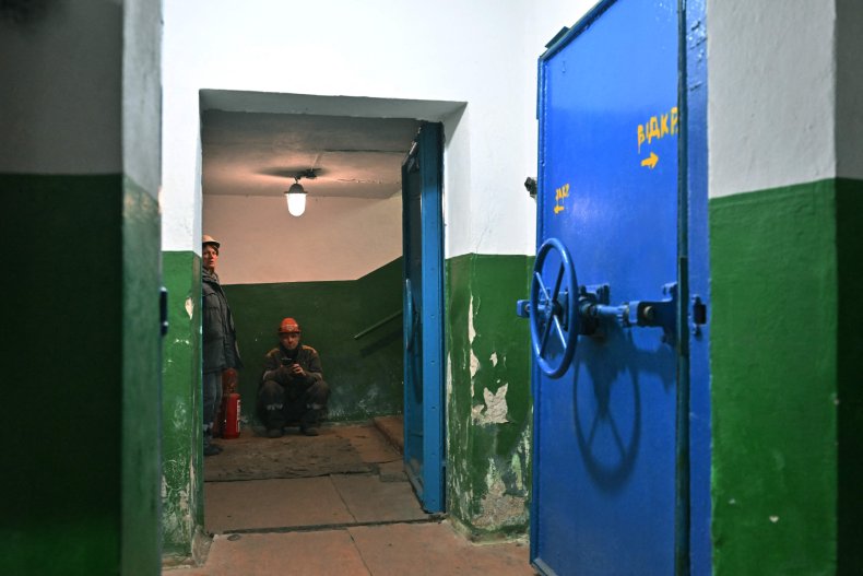 Workers wait in a Ukrainian bomb shelter