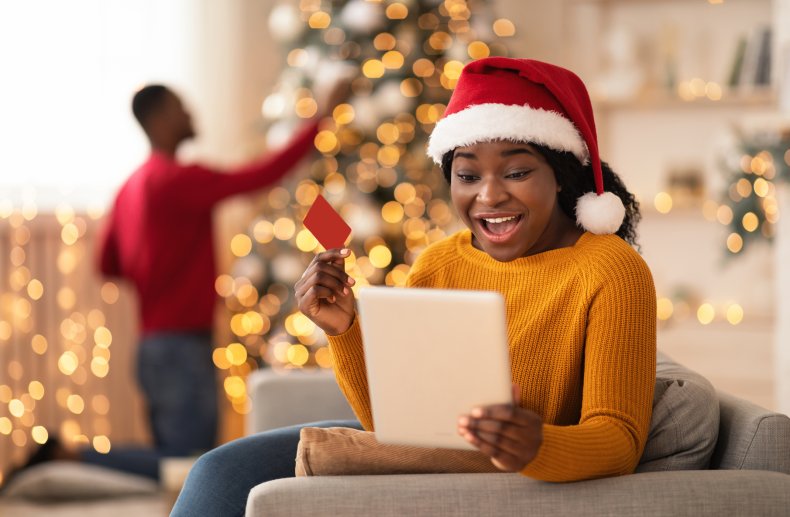 Woman in a Santa hat shopping online