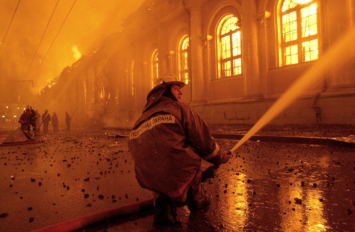 Firemen spray water onto a huge fire