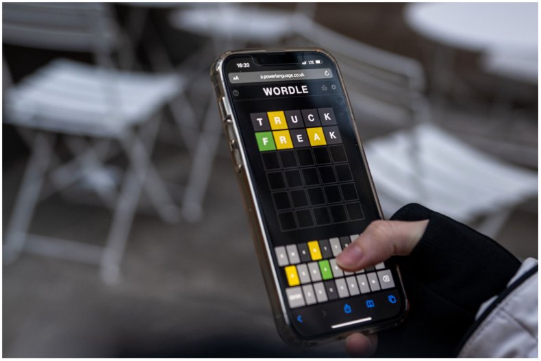 Woman playing Wordle on her phone