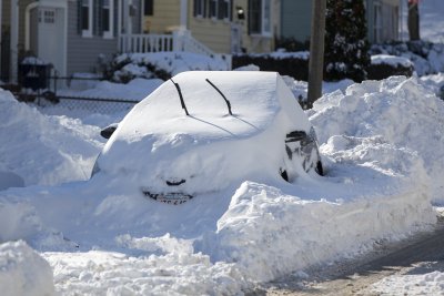 Car under snow after bomb cyclone