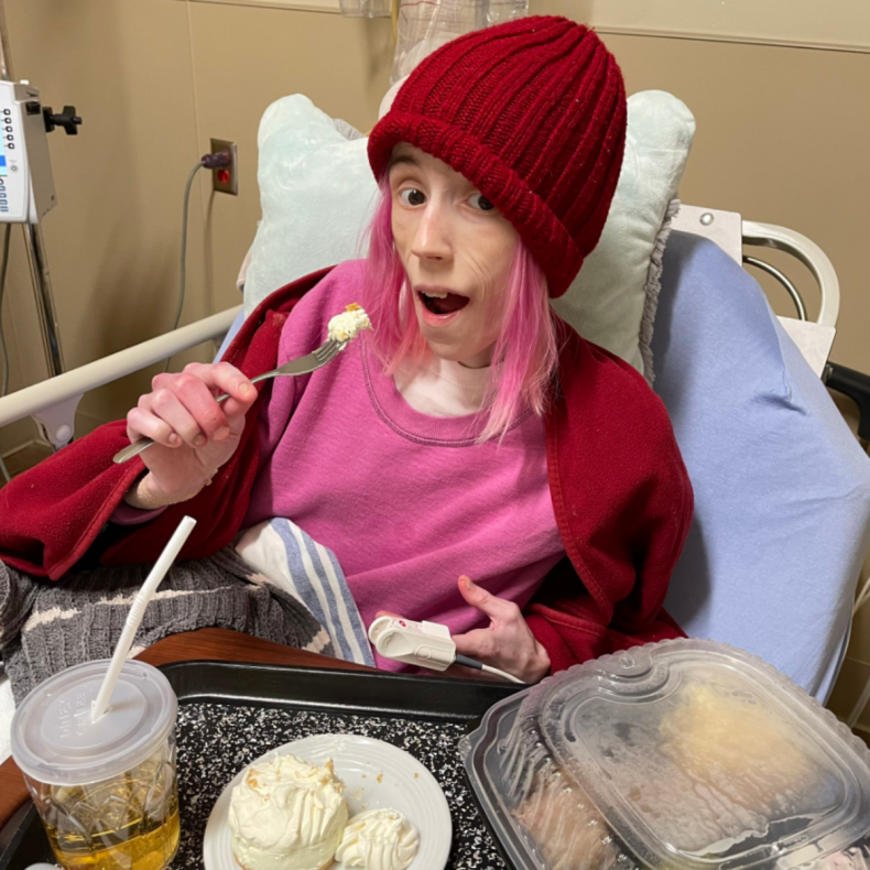 Lora Marsh eating a meal in a hospital bed