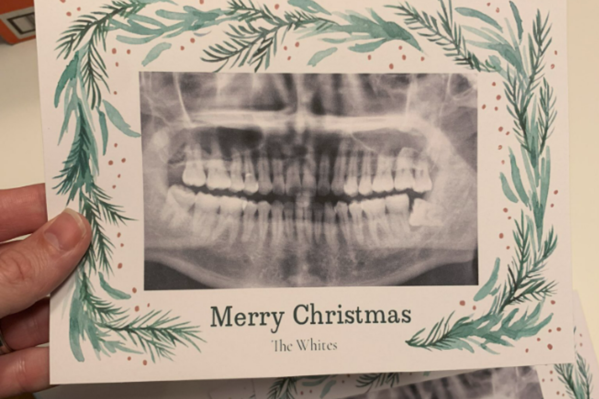 Man Stuck With 90 Christmas Cards of Neighbor's Teeth After Photo App Fail