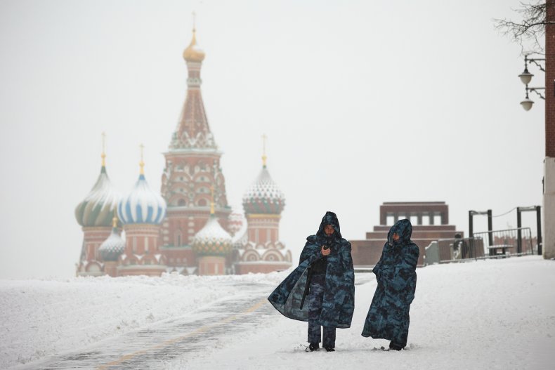 Police officers guard the snow-covered Red Square