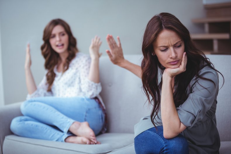 Two women arguing on couch.