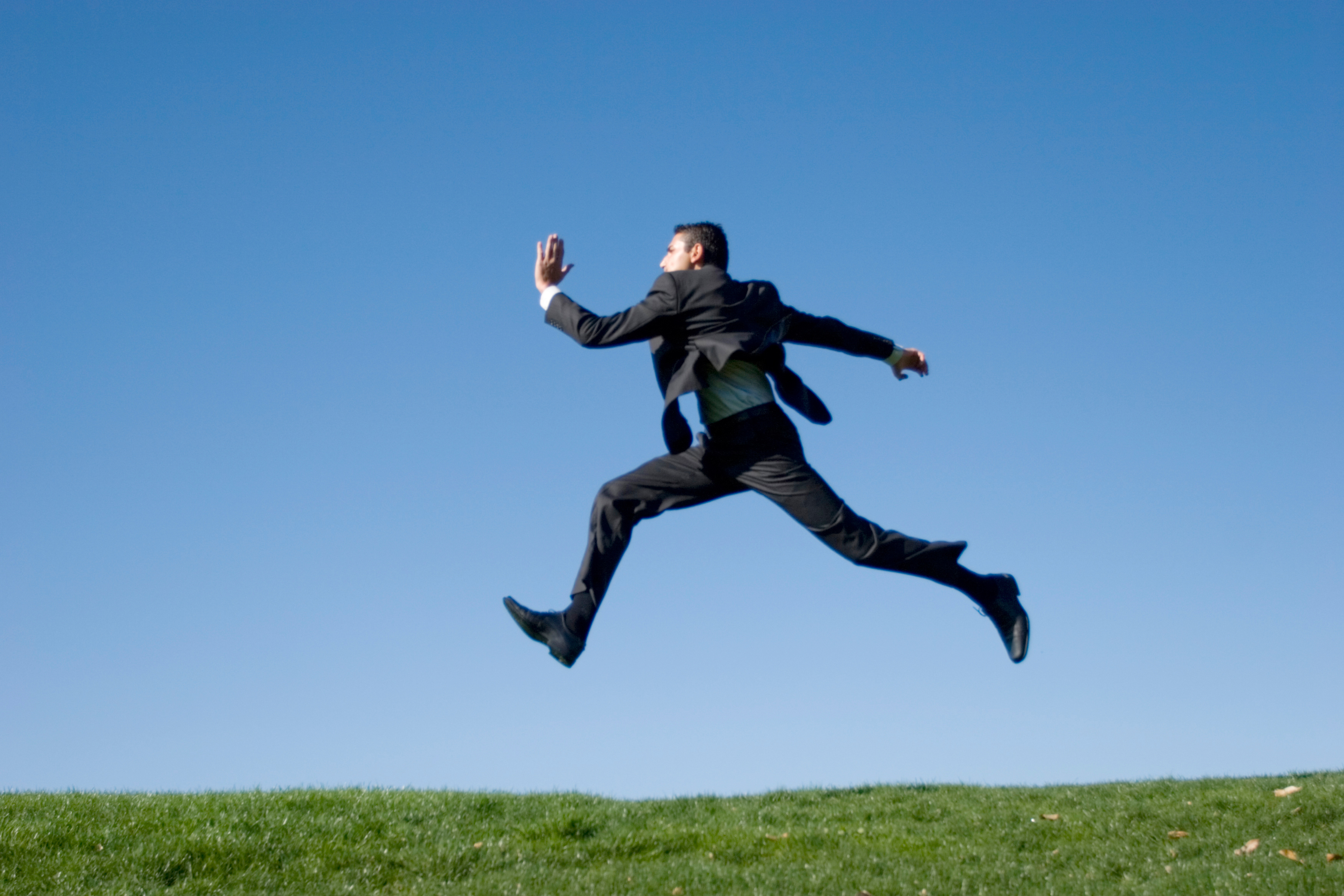 Businessman jumping in the air