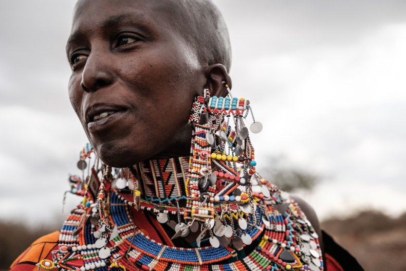 A Maasai woman dances at a village 