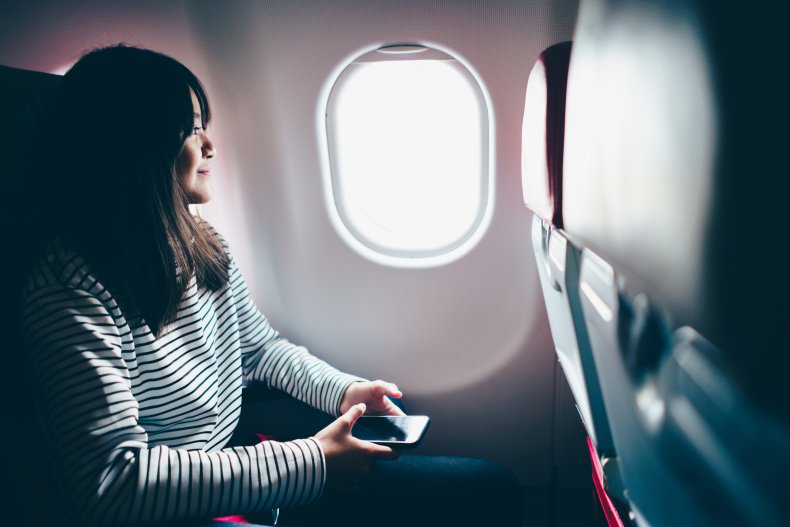 Passenger looking out plane window.