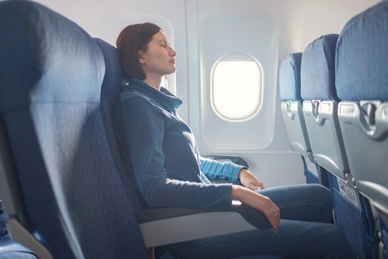 Passenger looking ill on plane.