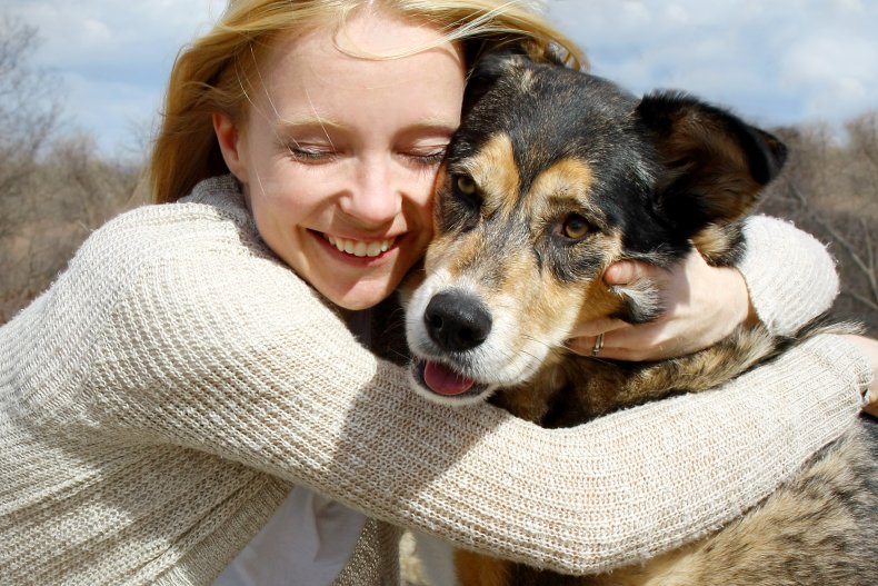 Woman hugging a German shepherd dog. 