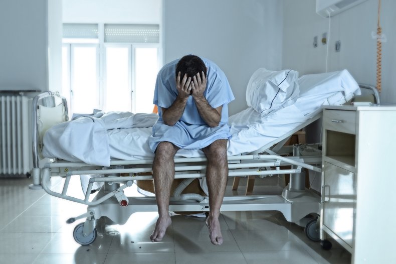 Man alone on hospital bed